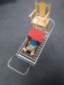 A mid 20th century metal doll's crib and a wooden doll's pram and high chair