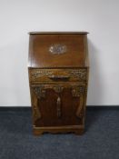 An early 20th century carved oak bureau