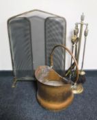 A brass three-way folding spark guard together with a four-piece brass companion set on stand and