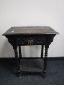A 19th century carved oak occasional table fitted a drawer
