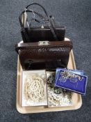 A tray of two vintage leather handbags, costume jewellery,