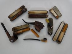 A box of vintage pipes and cheroots (one with gold rim)