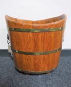 A wooden brass bound planter with lion mask handles