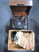 An early 20th century cased table top record player together with a box containing 78's and 45's