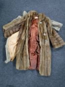 A Canadian fur coat and a simulated fur coat