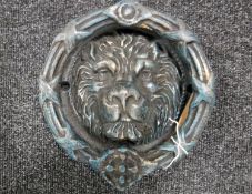 A cast iron lion head door knocker
