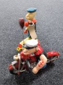 Two cast iron Popeye figures - motor cycle and boxing