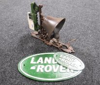 A cast iron Land Rover bell and two plaques