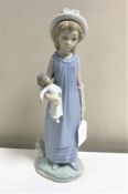 A Lladro figurine : Belinda with her Doll, model 5045, height 29 cm, boxed.