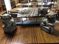 A wooden figure of a reclining Buddha and two hand painted wooden foo dogs
