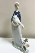 A Lladro figurine : Girl with Goose and Dog, 4866, height 27 cm, boxed.