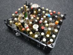 A basket containing approximately seventy-five alcohol miniatures