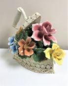 A Capo Di Monte ceramic model : Flat iron holding mixed flowers, height 28 cm.