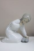 A Lladro figurine : Girl with Slippers, model 4523, height 13 cm, boxed.