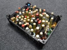 A basket containing approximately seventy-five alcohol miniatures