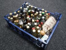 A basket containing approximately seventy-five alcohol miniatures