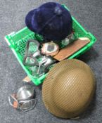A basket of riding hat, WWI helmet,