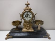 A nineteenth century ornate cast metal clock garniture,