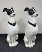 A large pair of metal dog figures on stands