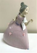 A Lladro figurine : Girl in Pink Dress with Flower, model 5120, height 28 cm, boxed.
