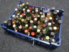A basket containing approximately seventy-five alcohol miniatures