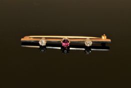 A three stone ruby and diamond bar brooch