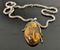 A Sterling silver mounted amber style pendant on chain