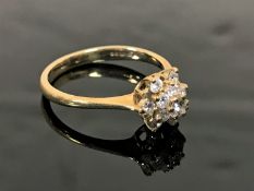 A 9ct gold diamond cluster ring, size M.