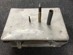 A metal military ammunition case containing shells