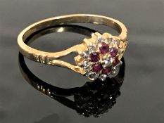 A 9ct gold diamond and ruby cluster ring, size M.