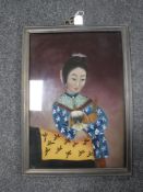 A Chinese reverse painting on glass depicting a lady with a dog