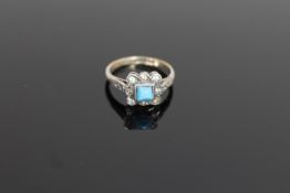 An early twentieth century silver dress ring set with a turquoise stone