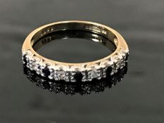 A 9ct gold diamond and sapphire half eternity ring, size N.