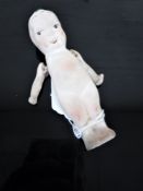 A WWI ceramic 'Fums-Up' doll.