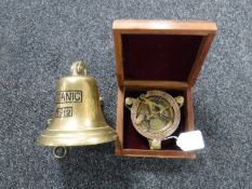 A brass cased ship's compass in a fitted mahogany box and a 'Titanic' ship's bell