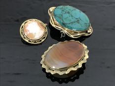 A yellow metal mounted cameo brooch together with two antique brooches set with agate and malachite