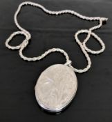 A silver locket suspended upon a sterling silver chain
