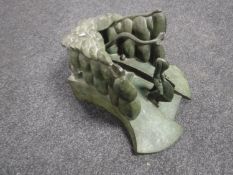 A bronze sculpture by Colin On of abstract step form