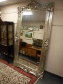 A large silvered framed mirror,