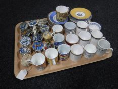 A tray of twelve Morgan Collection china pill boxes and assorted coffee cans,