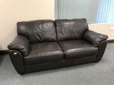 A brown leather two seater settee