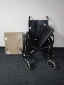 A folding wheel chair and a boxed over bed table