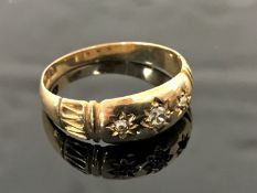 An 18ct gold ring set with three diamonds, size O.