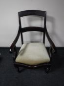 A late 19th century scroll arm armchair