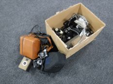 A box of vintage cameras including Olympus OM