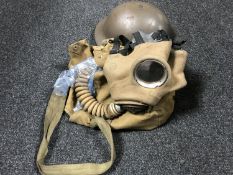 A crate containing WWII military helmet and respirator