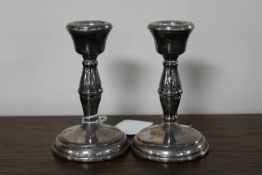 A small pair of silver candlesticks, height 10.