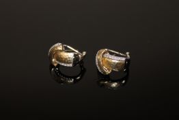 A pair of two tone gold diamond set hoop earrings