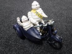 A cast iron figure - Michelin on motorcycle and side car