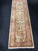 A fringed contemporary Persian style runner on rust ground,